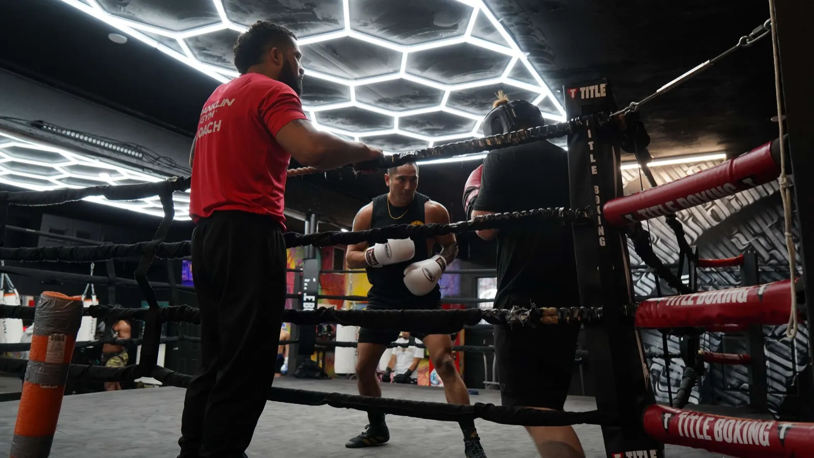 Coach working with a fighter ringside at Franklin Gym